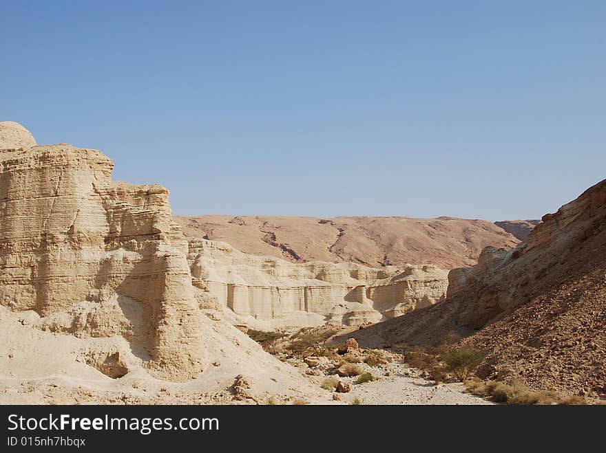 The dried up channel of the river in Judaic mountains near to the Dead Sea. The dried up channel of the river in Judaic mountains near to the Dead Sea