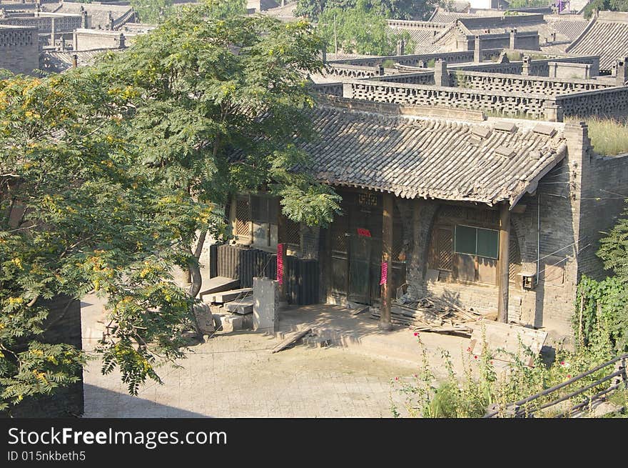 Ancient city Pingyao in China,there is courtyard,old house and trees in the courtyard. Ancient city Pingyao in China,there is courtyard,old house and trees in the courtyard.