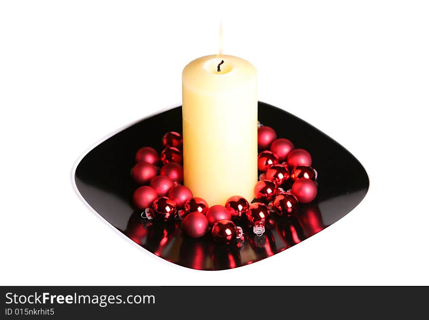 Large white candle burning in holiday setting