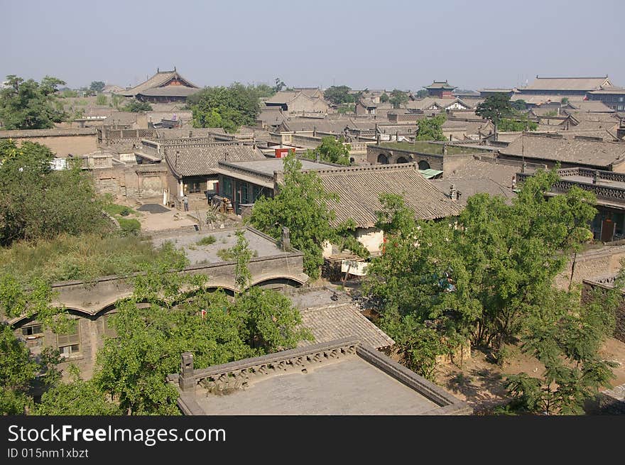 Ancient city Pingyao in China,old house and trees in the town. Ancient city Pingyao in China,old house and trees in the town.