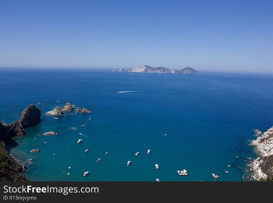 Sea view of blue mediterranean sea, coast and boats. Ponza's coast. Island of Ponza, Italy. Sea view of blue mediterranean sea, coast and boats. Ponza's coast. Island of Ponza, Italy.