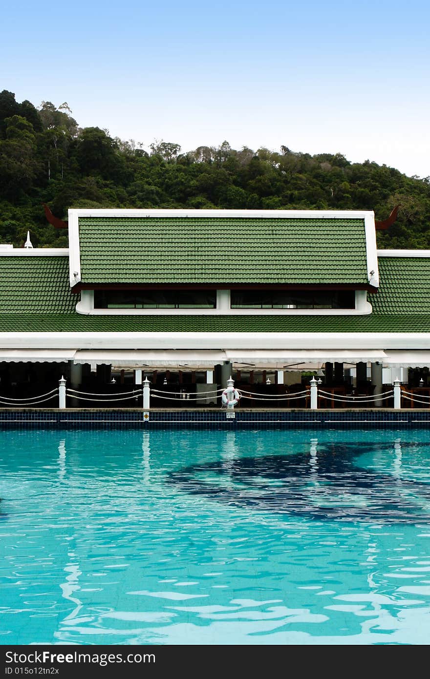 Tropical resort buildings and swimming pool.