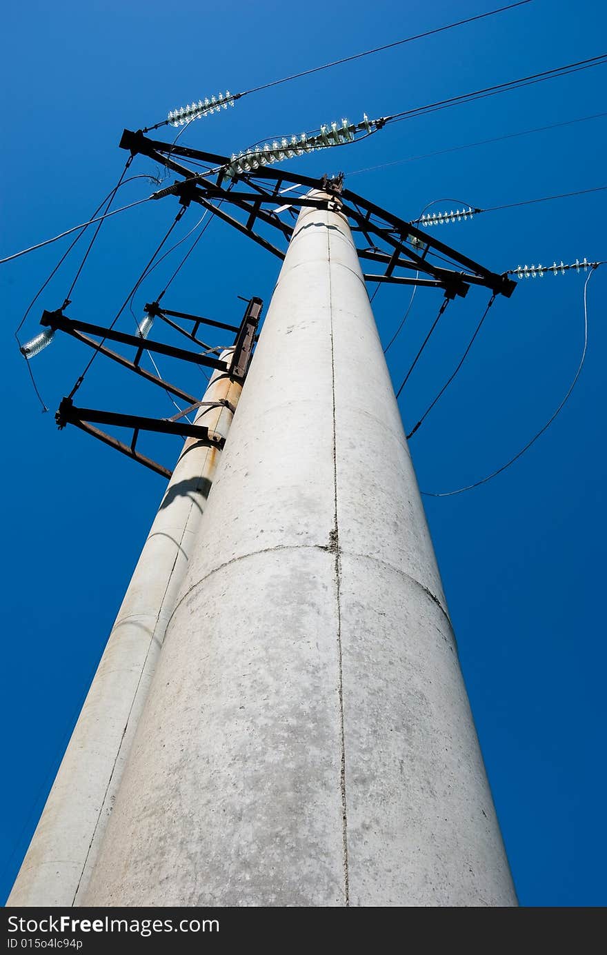 High voltage electric pillar against blue sky