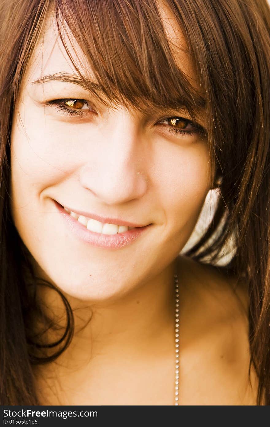 Young woman smiling at camera. Young woman smiling at camera.