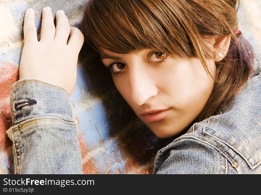 Young woman on brickwall