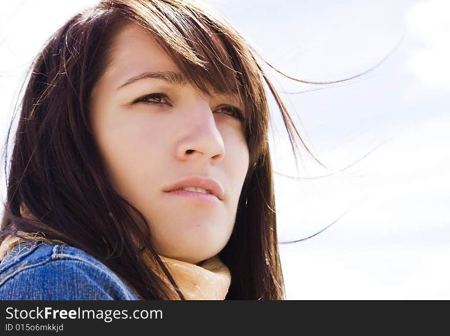 Close woman portrait with her hair on the wind.