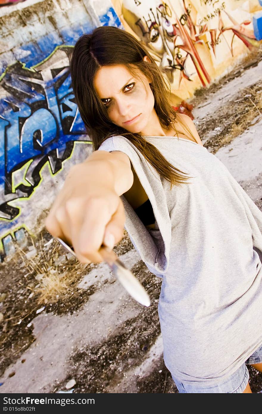 Young woman threatening with a knife. Young woman threatening with a knife