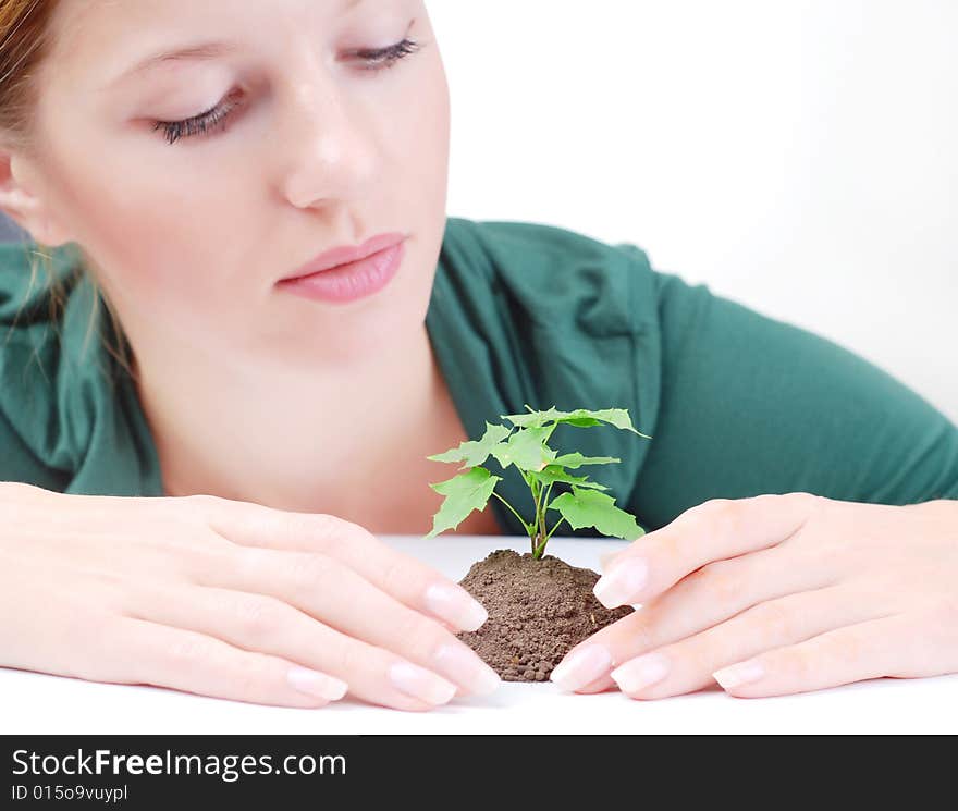 Beautiful young woman with green sprout of tree. Beautiful young woman with green sprout of tree