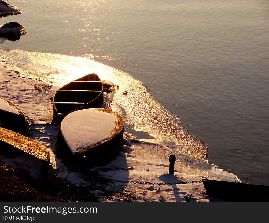 Boats near a bank on sunset of a sun