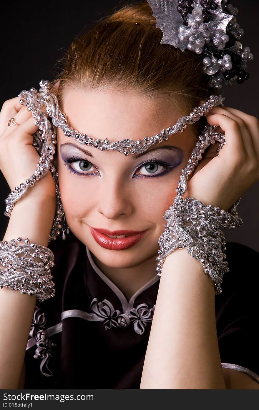 The beautiful girl with silver ornaments