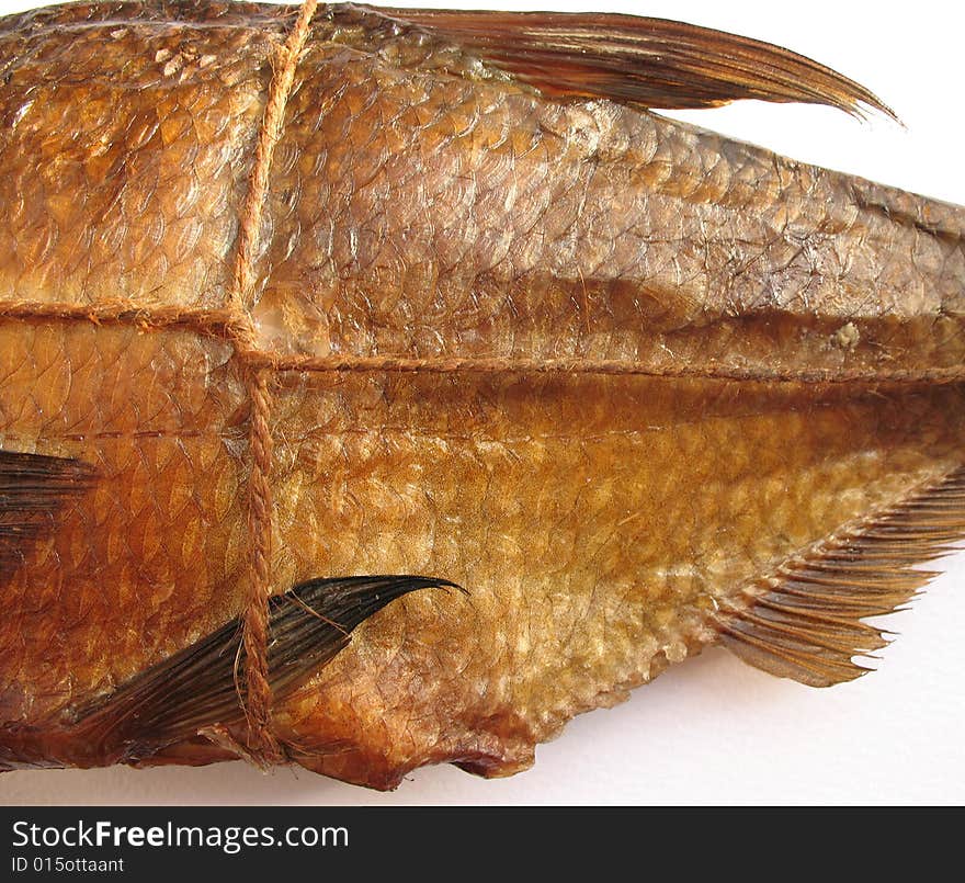 A hot smoked fish on the white background. A hot smoked fish on the white background