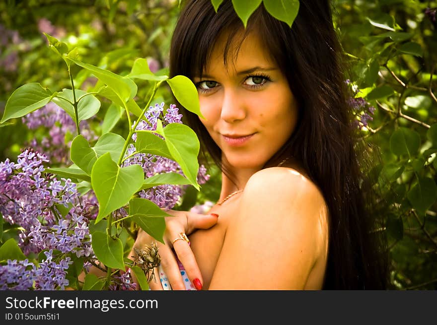 The girl and blossoming lilac