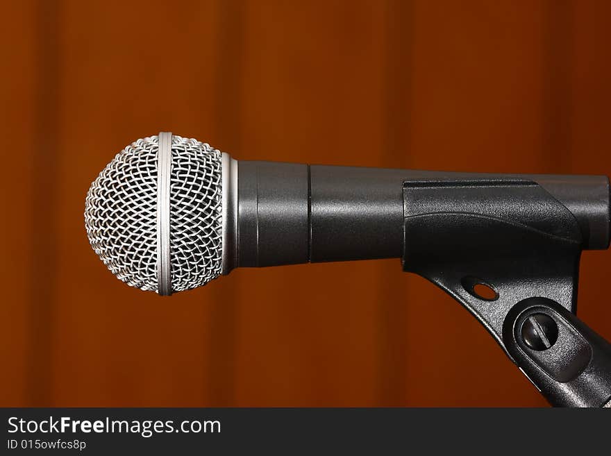 Silver-black studio microphone on rusty background