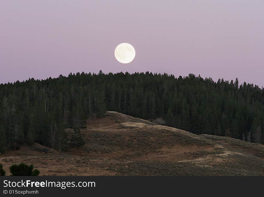 Full moon above the hills in Yellowstone park