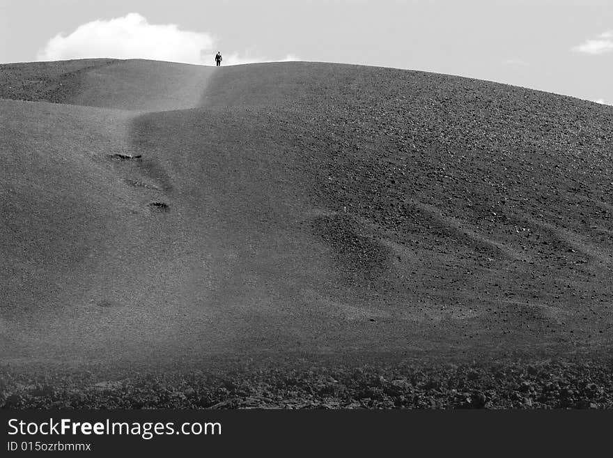 Lone figure on the top of the hill in black and white. Lone figure on the top of the hill in black and white