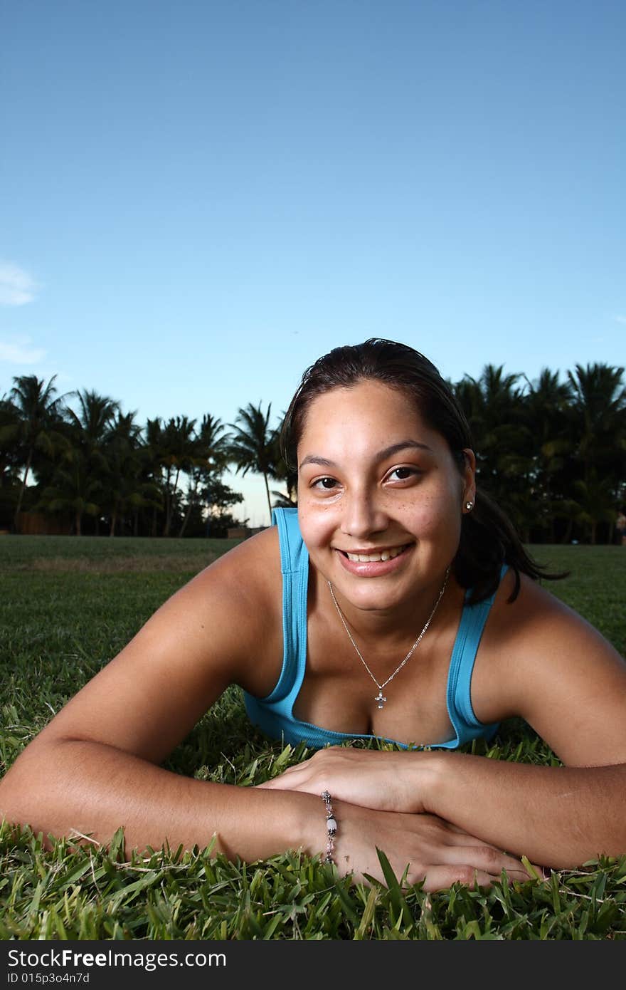 Young woman laying on grass