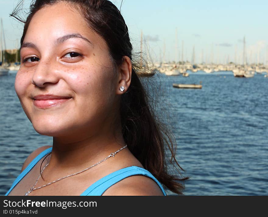 Head and shoulder shot of a young female smiling. Head and shoulder shot of a young female smiling.