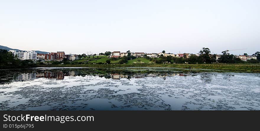 The reflection of that village on the river water. The reflection of that village on the river water