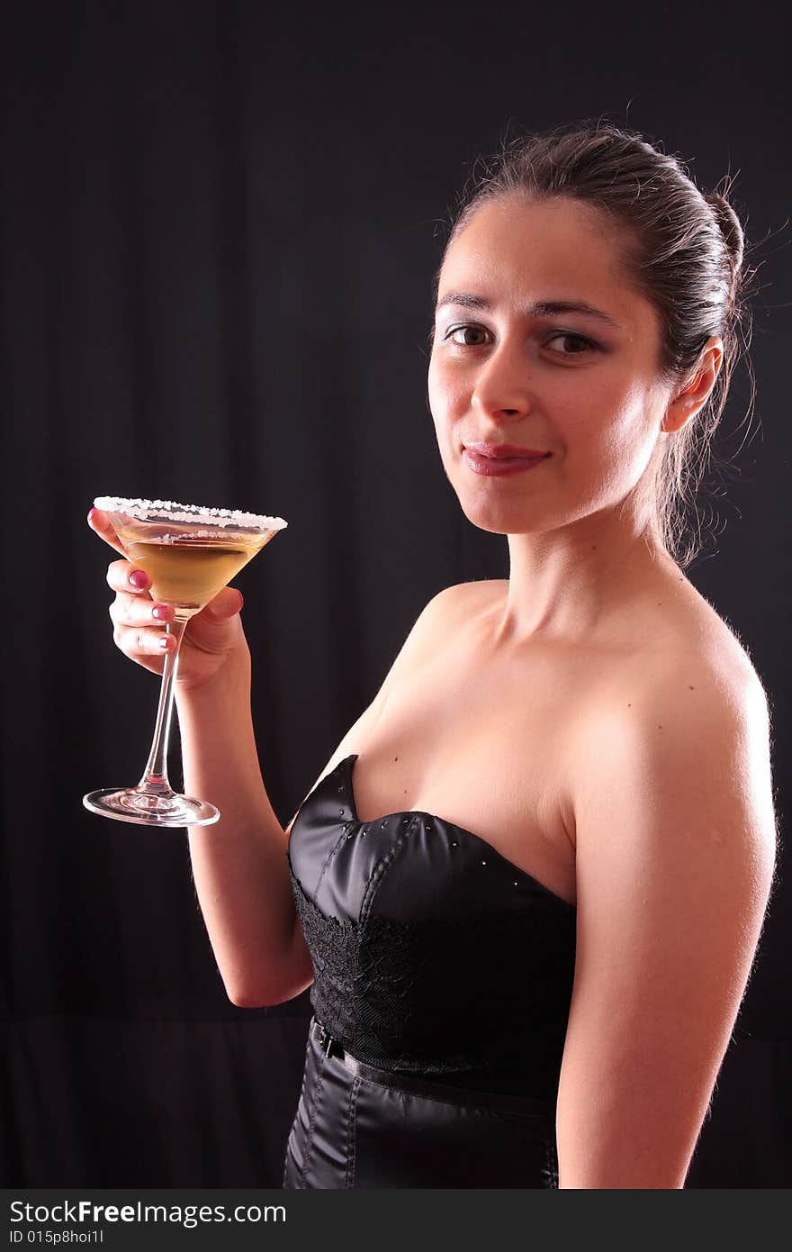Beautiful young woman holding a martini glass. Beautiful young woman holding a martini glass