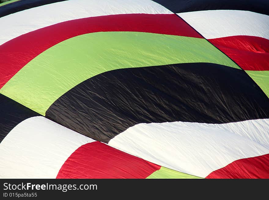 Closeup of a multi-colored hot air balloon being inflated