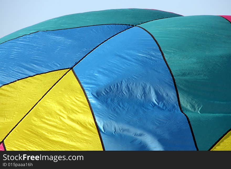 Closeup of a multi-colored hot air balloon being inflated