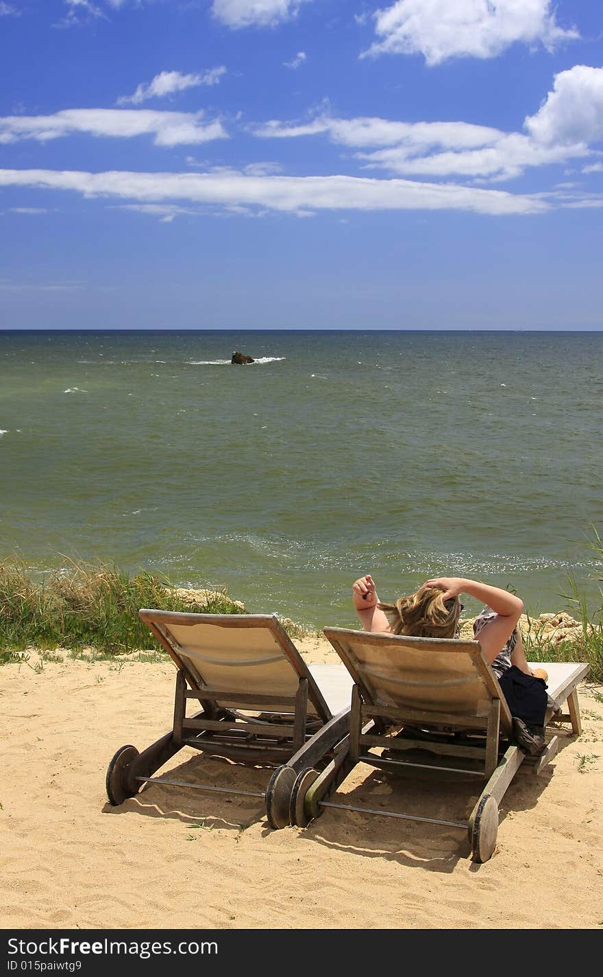 Woman relaxing on the top of the cliff