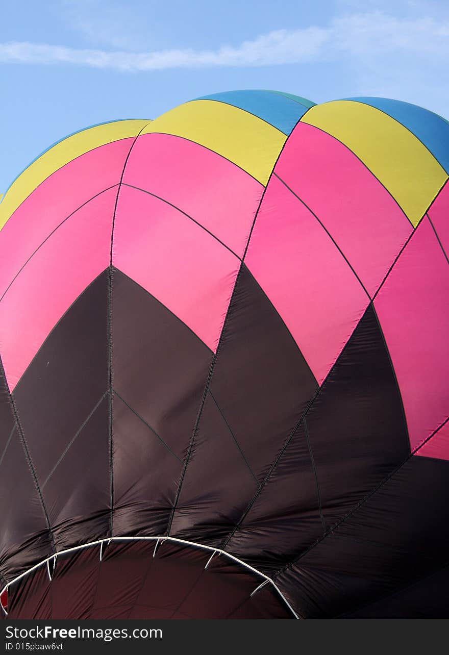 Closeup of a multi-colored hot air balloon being inflated