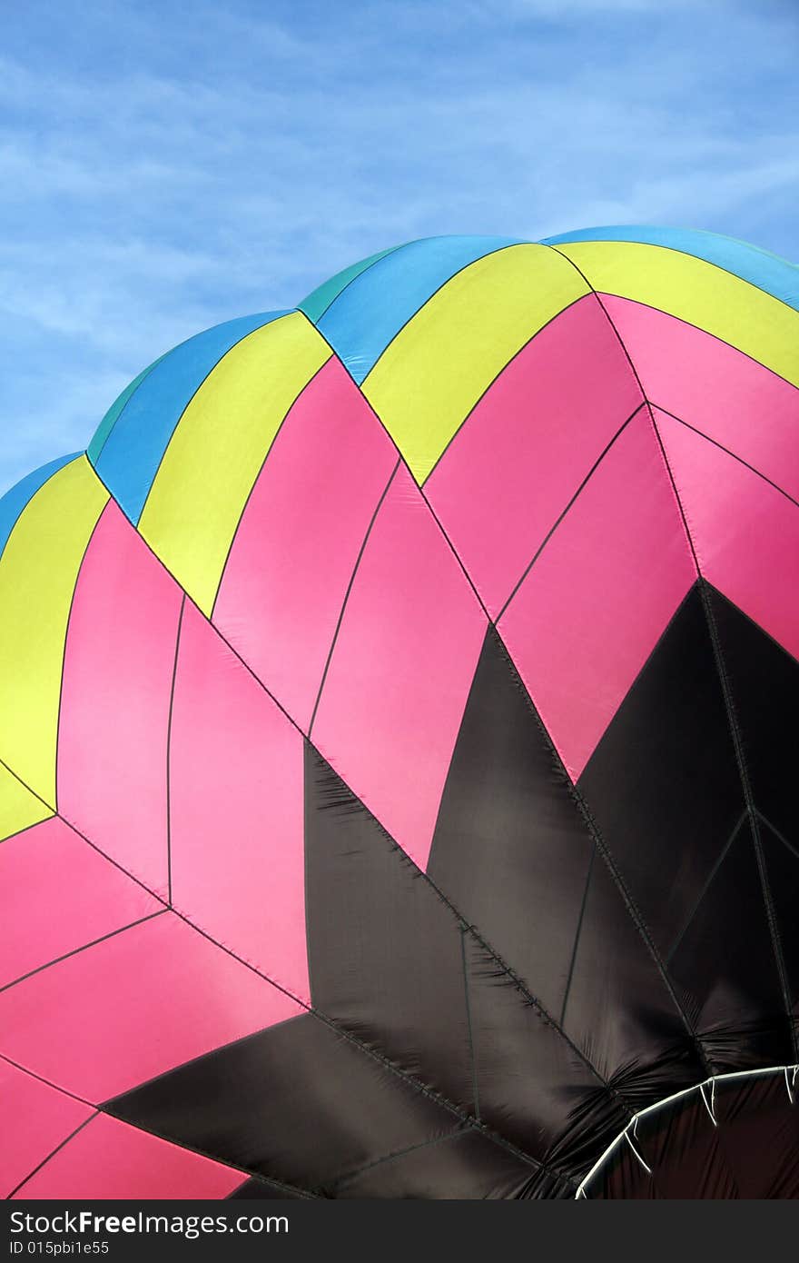 Closeup of a multi-colored hot air balloon being inflated