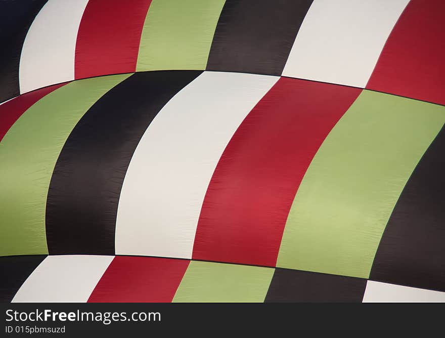 Closeup of a multi-colored hot air balloon being inflated