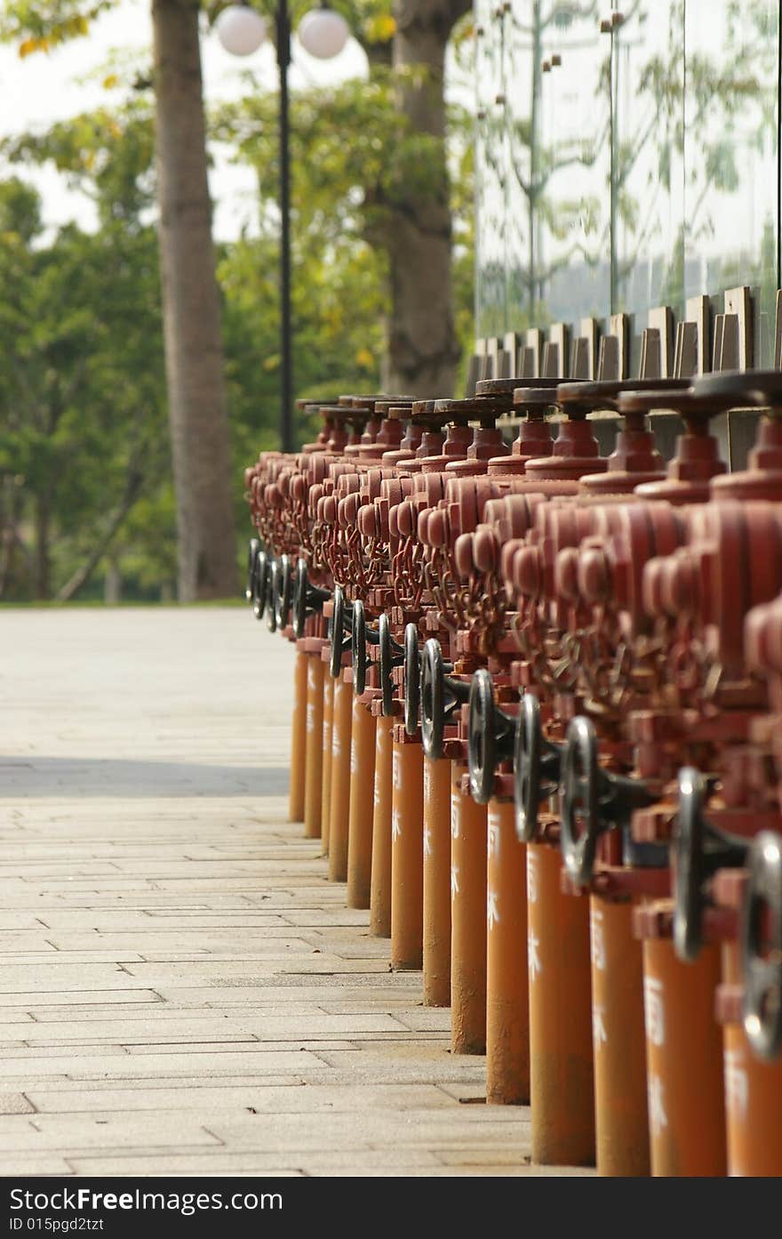 Some red fire hydrant on the ground.