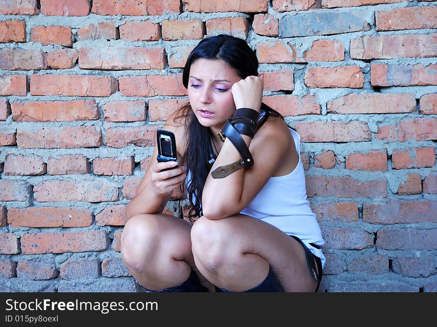 The girl near a brick wall