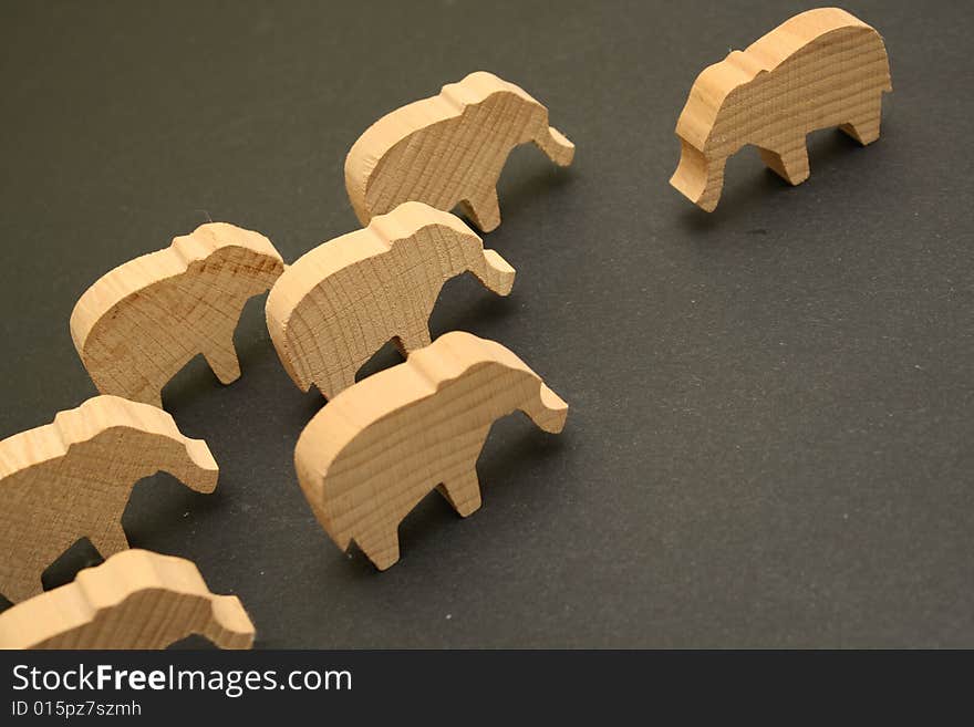 Against the background of the same faces several wooden elephants. Against the background of the same faces several wooden elephants