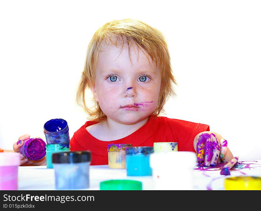 Little girl draws on a table isolated. Little girl draws on a table isolated