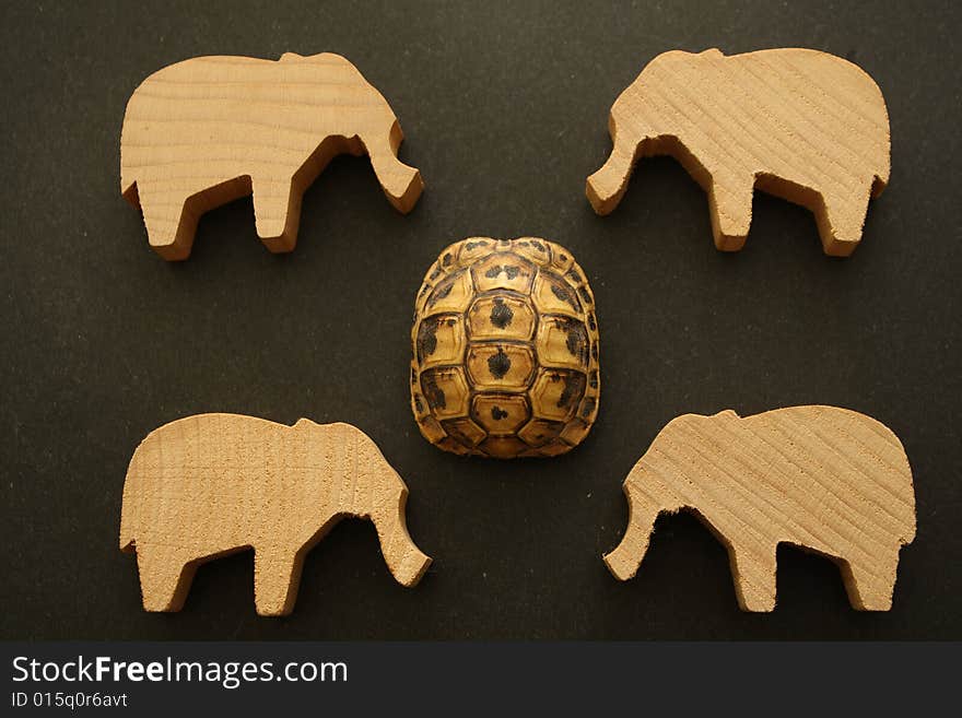 Against the background of the same faces several wooden elephants and skin of turtles. Against the background of the same faces several wooden elephants and skin of turtles