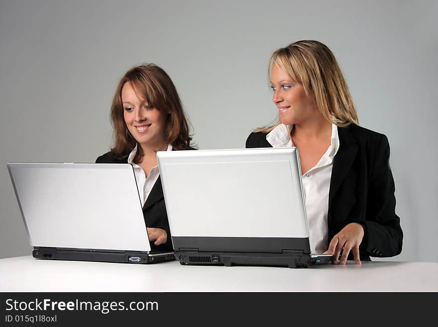 Two young woman with computers. Two young woman with computers