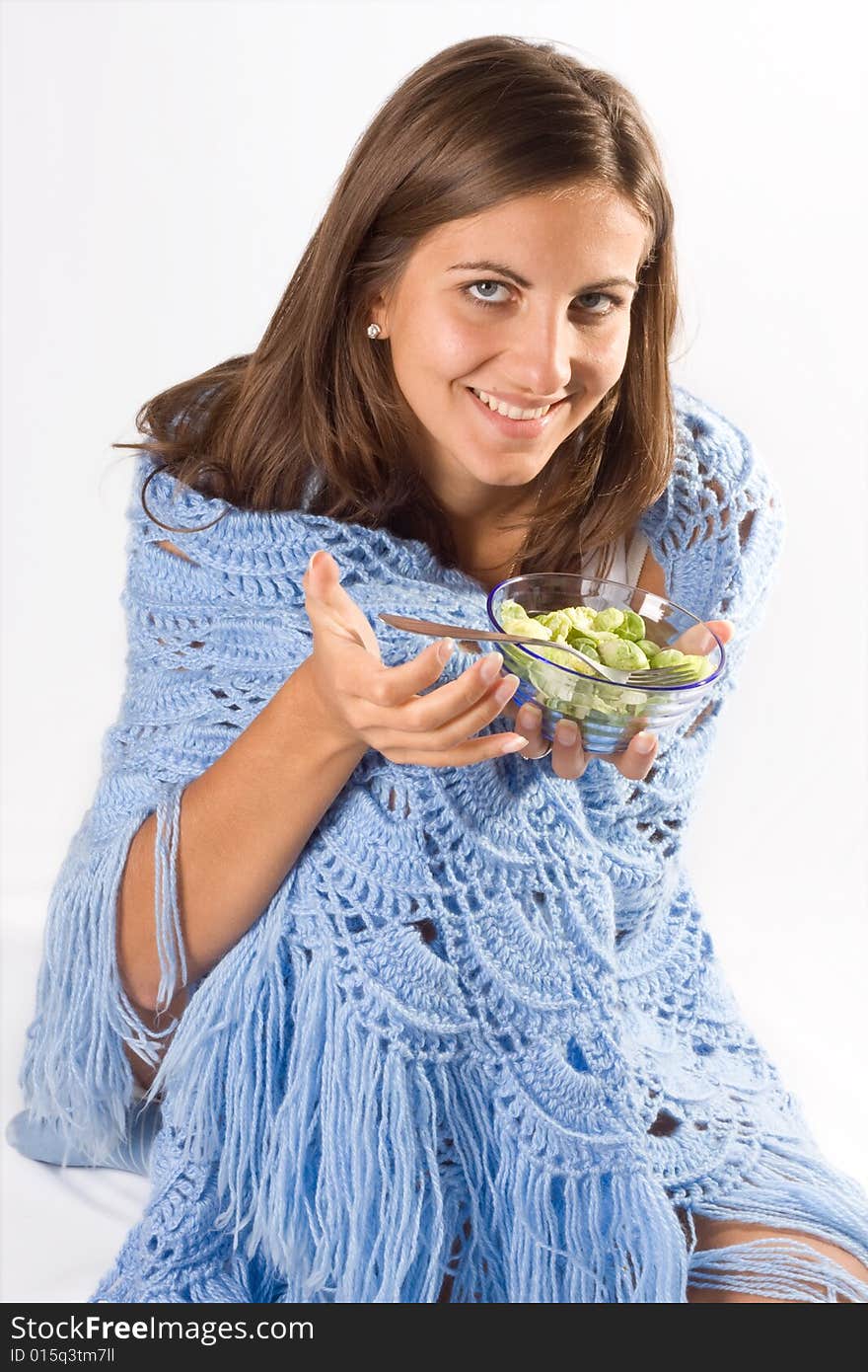 Portrait of young happy smiling woman eating salad