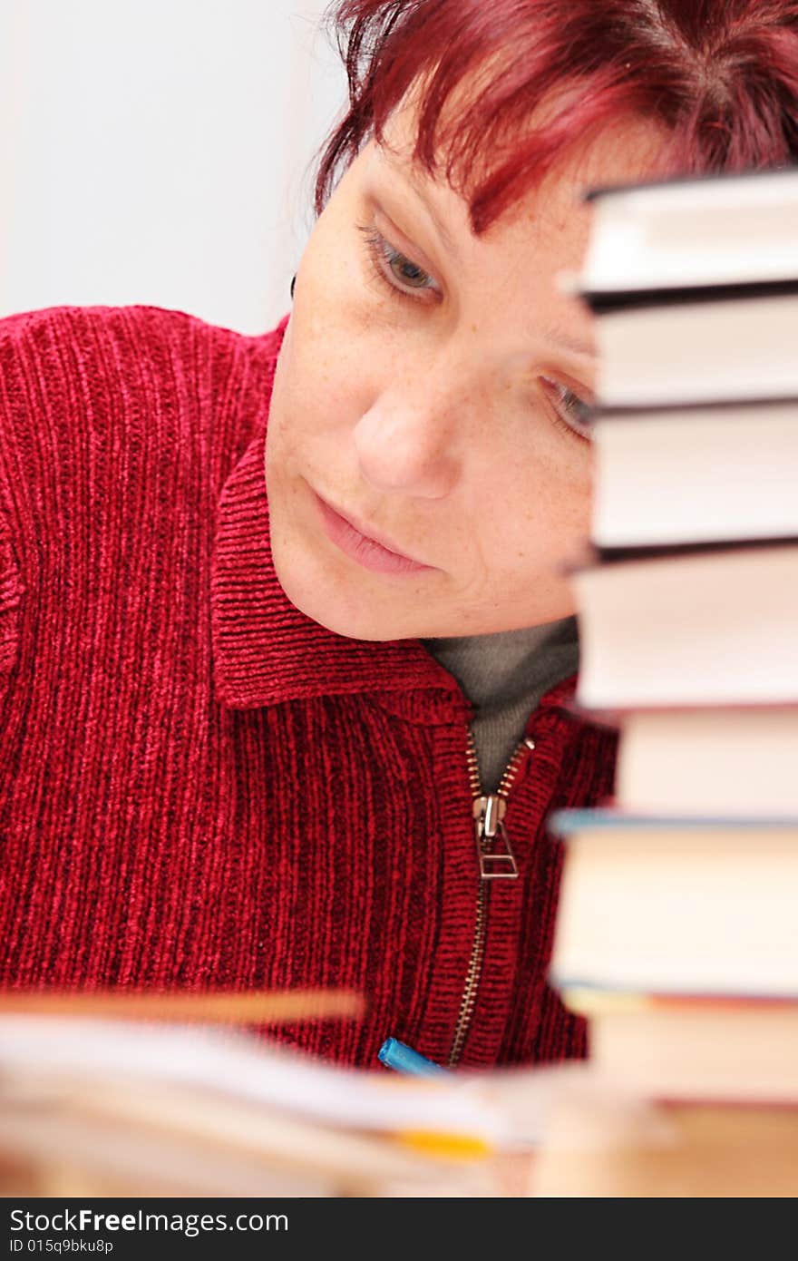 The woman closely studying the literature. The woman closely studying the literature