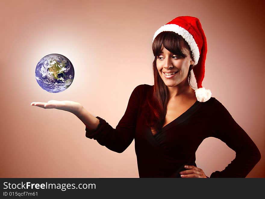 Woman with Santa Claus hat and a globe. Woman with Santa Claus hat and a globe