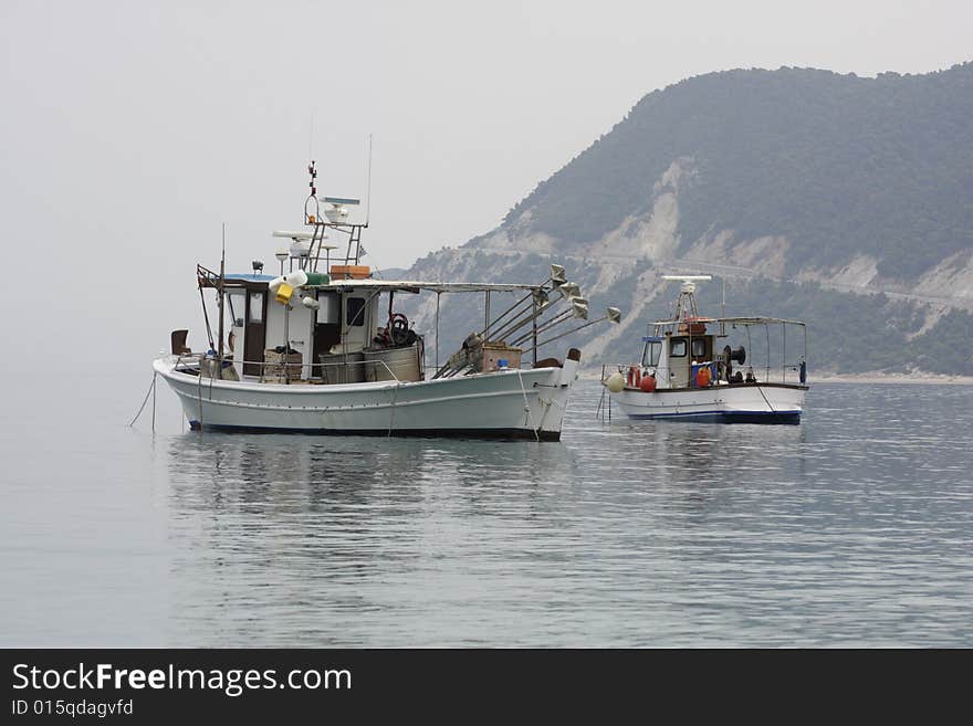 Two fishermen's boats anchored at the coastline. Morning seascape. Two fishermen's boats anchored at the coastline. Morning seascape.