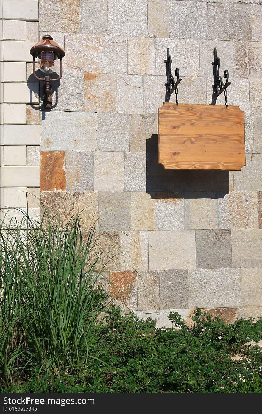 Brown wooden sign SPA on the stone wall.