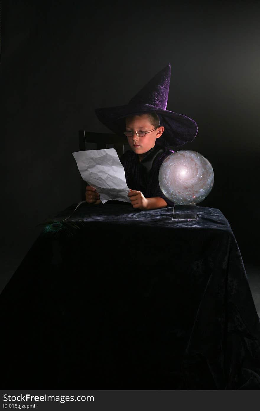 Wizard child reading a spell