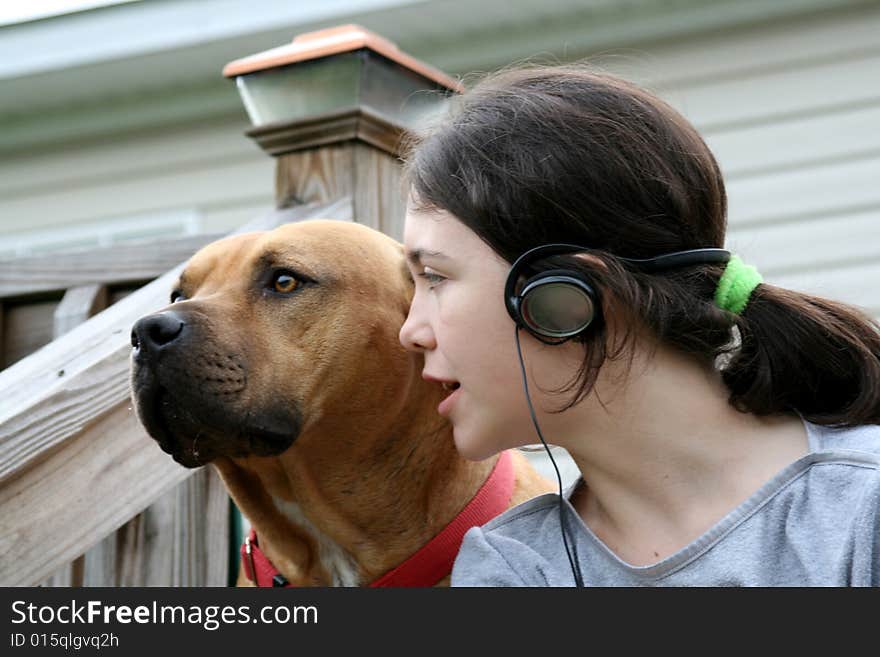 Girl and dog listening to music. Girl and dog listening to music