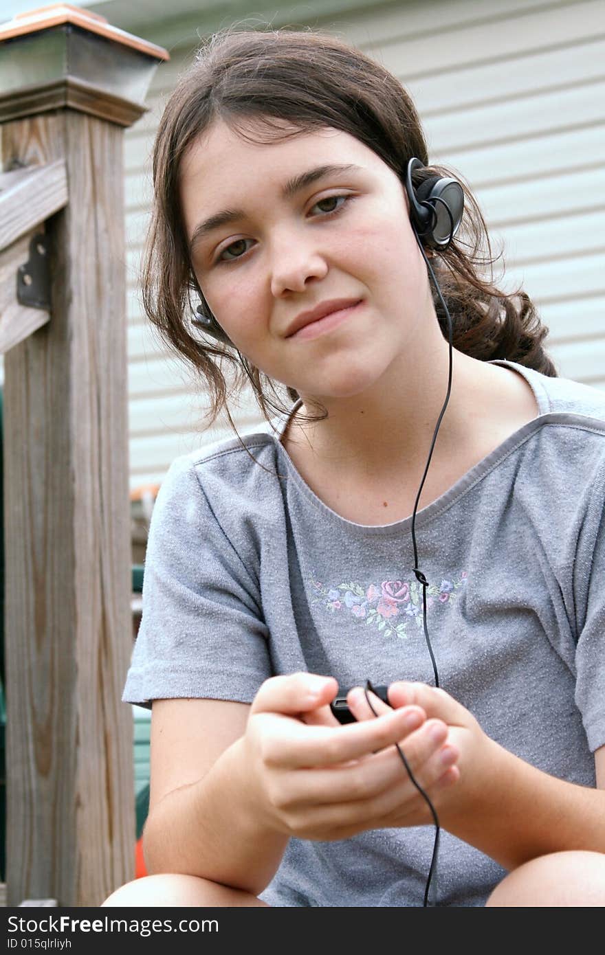 Teen girl listening  to mp3 player. Teen girl listening  to mp3 player