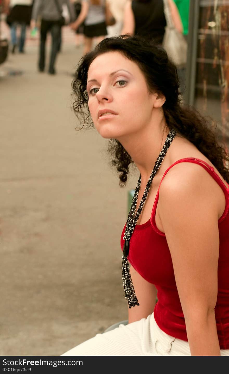 Outdoor portrait of beautiful brunette in red