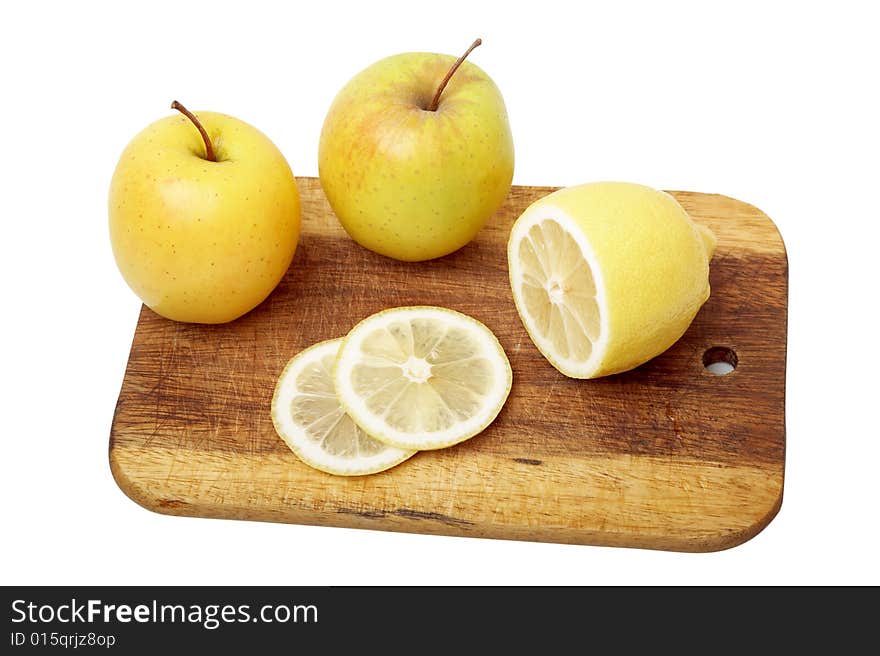 The apple cut by segments and lemon on a kitchen board. The apple cut by segments and lemon on a kitchen board