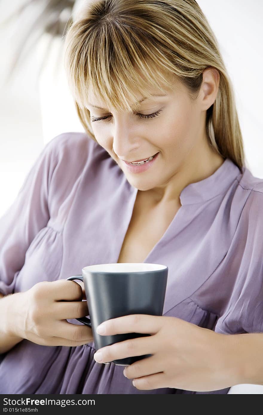 Female at home, with cup of something. Female at home, with cup of something