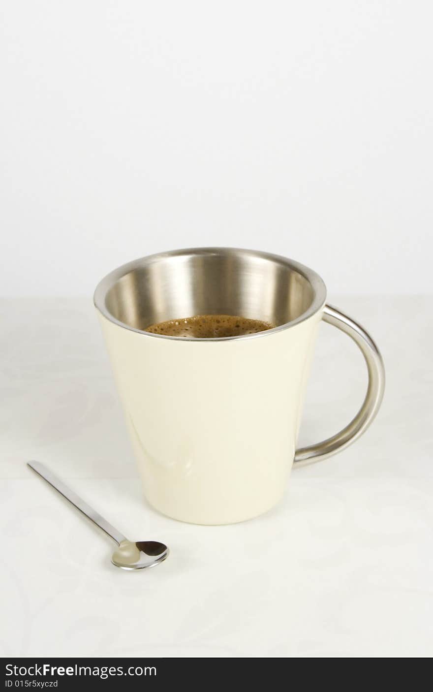 Metal mug and coffee spoon with clipping path