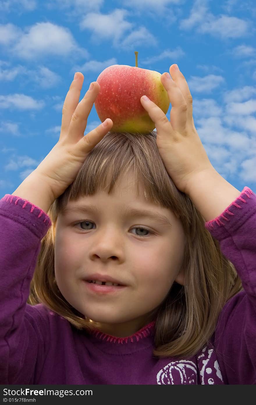 Girl with a red apple on her head