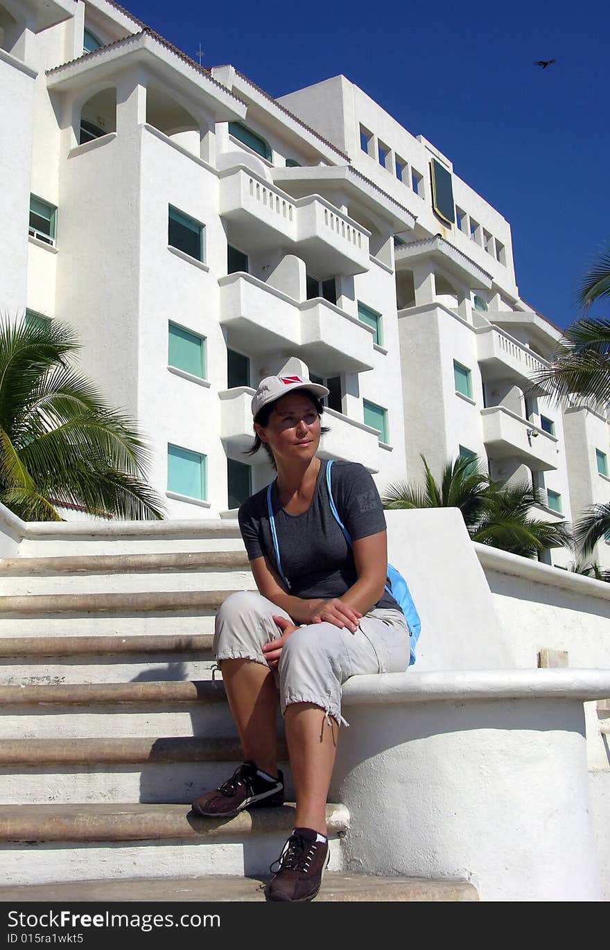 The girl resting near resort building in Manzanillo city, Mexico. The girl resting near resort building in Manzanillo city, Mexico.