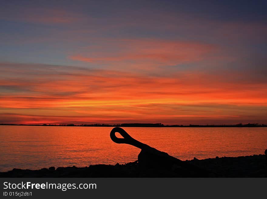 An abandoned anchor sits on the cold rocks bordering Lake Ontario. An abandoned anchor sits on the cold rocks bordering Lake Ontario.